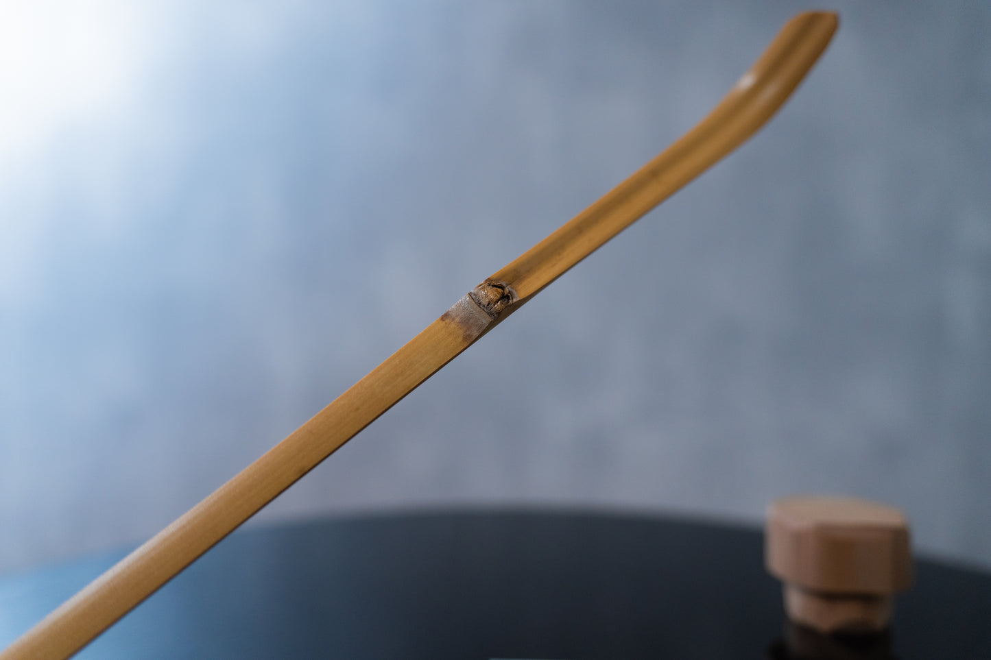 Emptea Katana Smoked Bamboo Scoop with a traditional tea chest (Chashaku 刀)